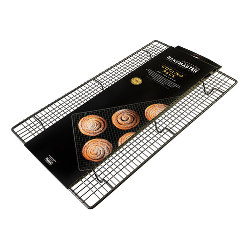 Rectangular wire cooling tray holding baked buns on a non-stick mesh grid