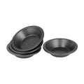 Set of four oval baking pans on a white background